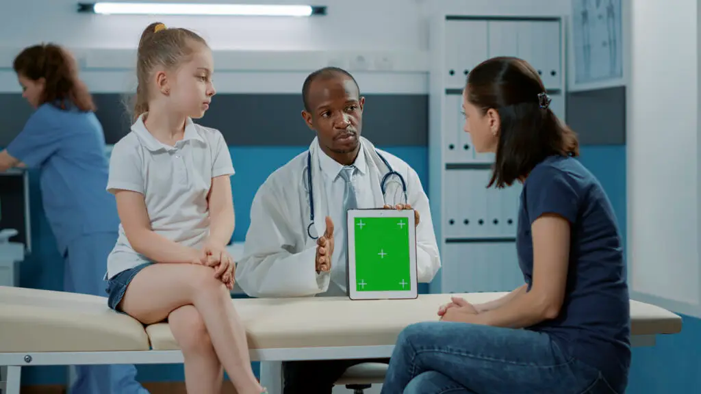Tripod shot of doctor using green screen background