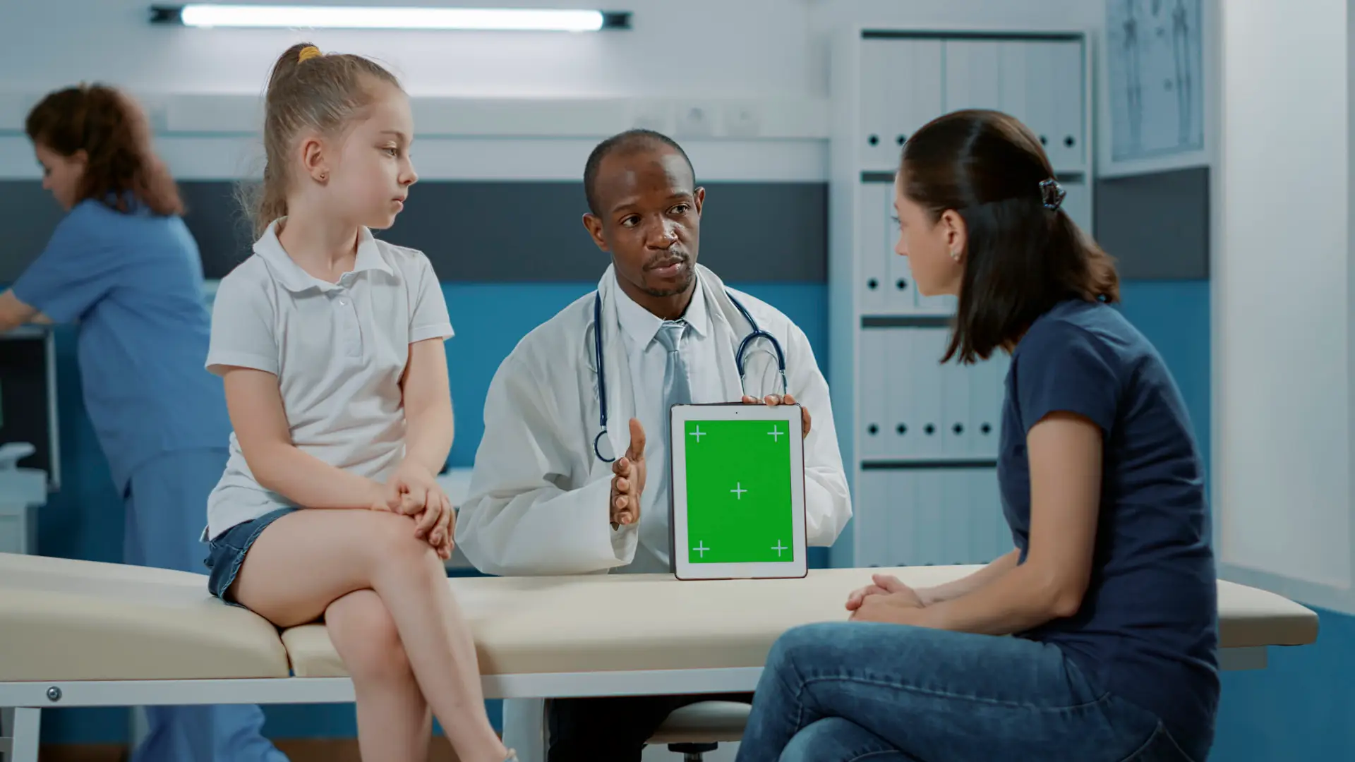 Tripod shot of doctor using green screen background