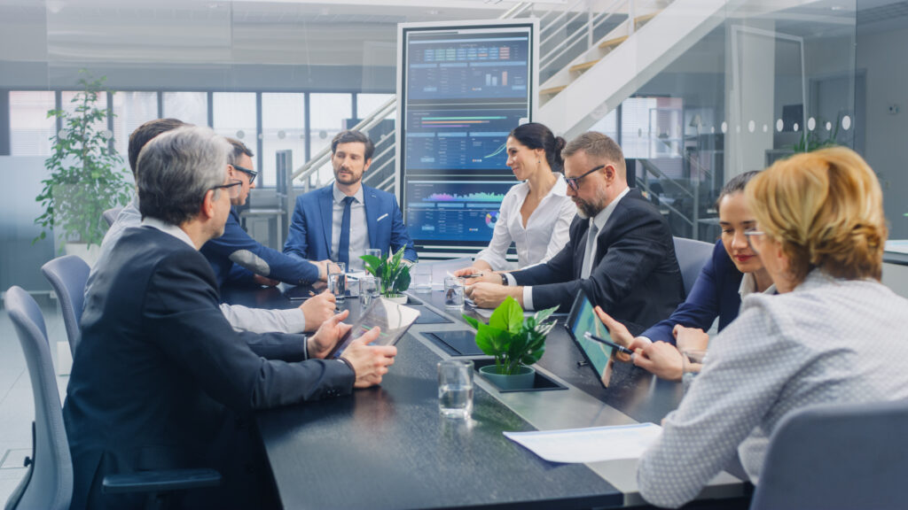 business meeting or event with multiple business people gathered in a room