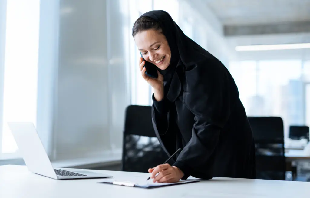 Beautiful arabian woman with abaya dress working