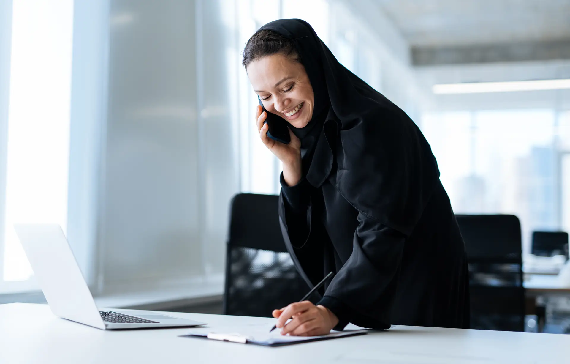 Beautiful arabian woman with abaya dress working
