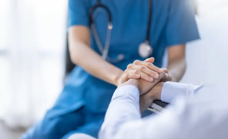 Cropped shot of a female nurse hold her senior patient's