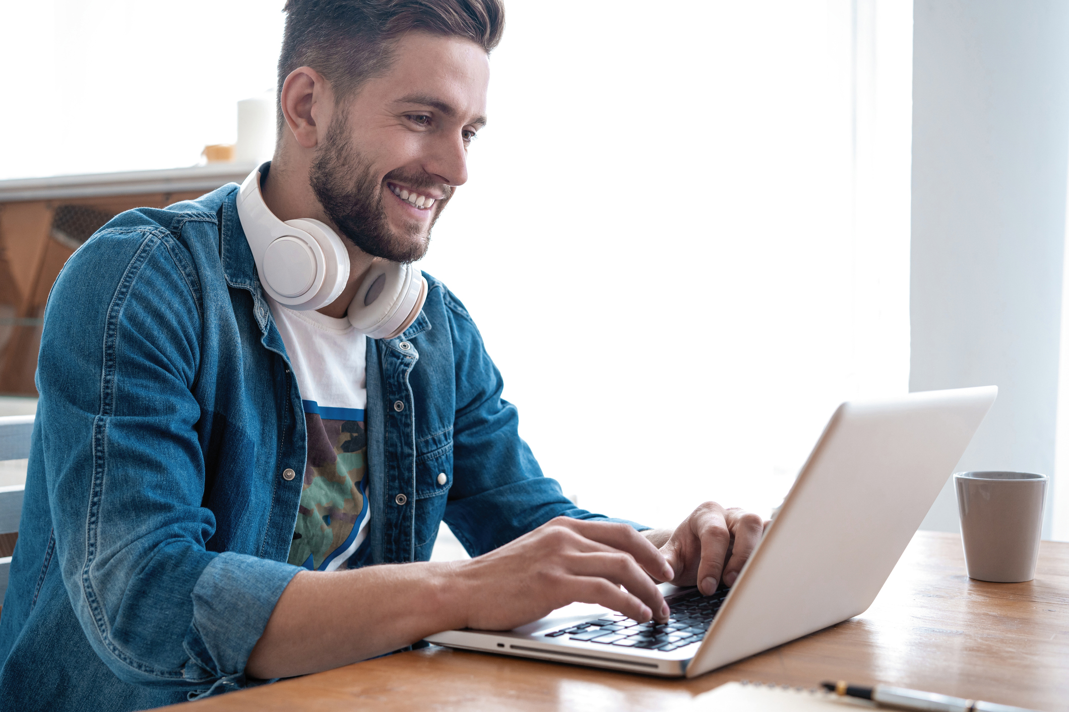Handsome modern man designer working on laptop online