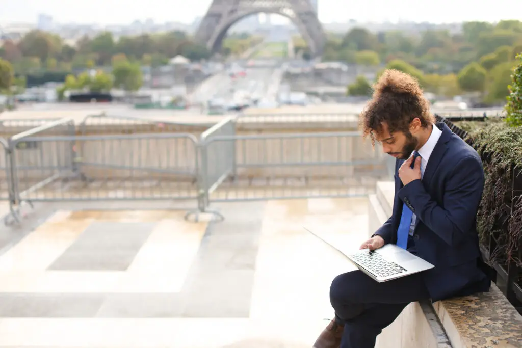 a french man outside near the eiffel tower